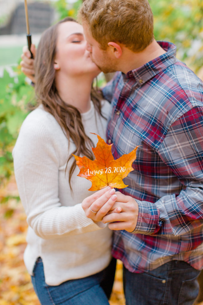 couple kissing in a fall engagement session with wedding date on leaf
- Rainy Day Engagement Session Downtown Ottawa - Photo Locations 

Grey Loft Studio - Ottawa Wedding Photographer & Videographer