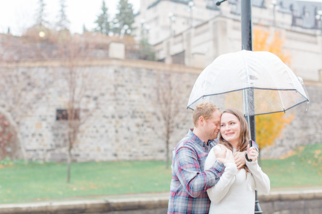 Couple standing in the rain during engagement session 