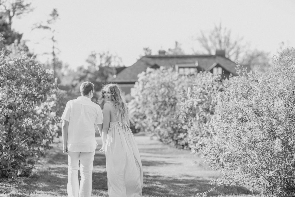 couple walking during an engagement session having fun in the Ornamental gardens ottawa Best Tips