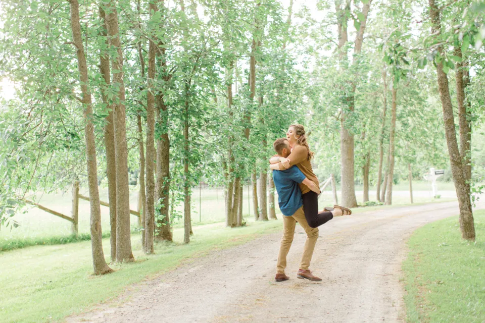 Frolic - Natural Posing for Photo Session - Couples Photo Session Fun - Fun on the Farm - Farm Engagement Session - Blue and Brown Engagement Session Inspiration - Natural Engagement Session Posing - Ideas for what to wear for Engagement Photography, Modern Engagement Session Inspiration Wardrobe Ideas. Unsure of what to wear for your engagement photos, we've got you! Romantic brown with black leggings for Summer Engagement in Almonte. Grey Loft Studio is Ottawa's Wedding and Engagement Photographer for Real couples, showcasing photos that are modern, bright, and fun.
