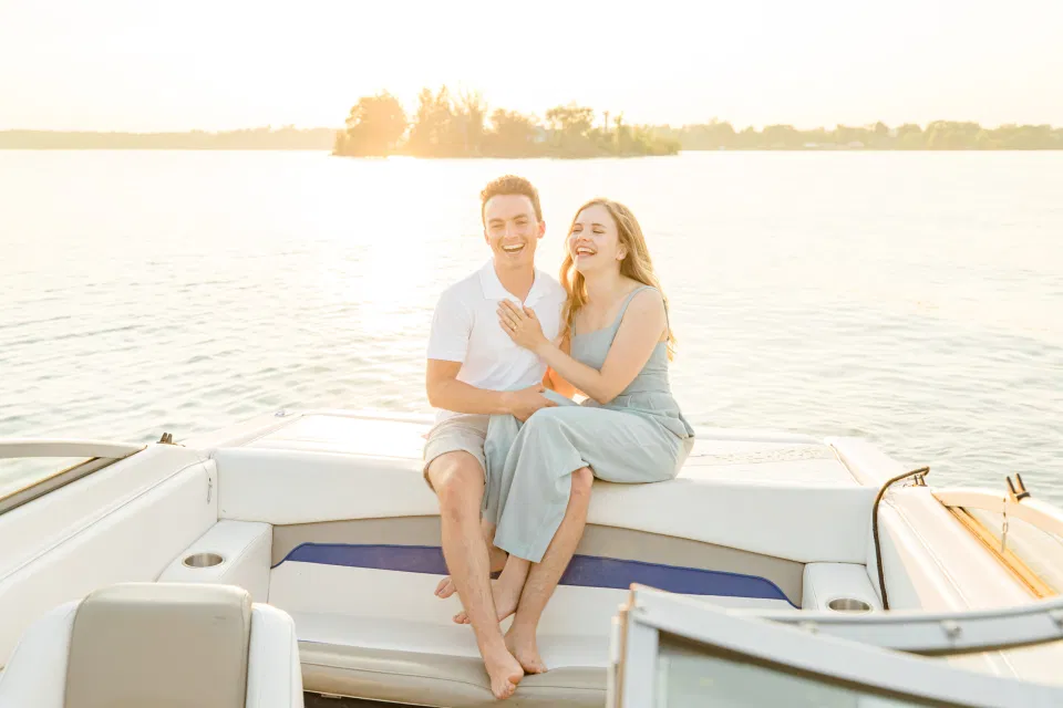 Boat Rides - Ideas for what to wear for Engagement Photography, Modern Engagement Session Inspiration Wardrobe Ideas. Unsure of what to wear for your engagement photos, we've got you! Romantic blue Romper and neutral Shirts and polo. Boat Shoes and Flip Flops. Engagement in Gananoque. Grey Loft Studio is Ottawa's Wedding and Engagement Photographer Videographer for Real couples, showcasing photos that are modern, bright, and fun.