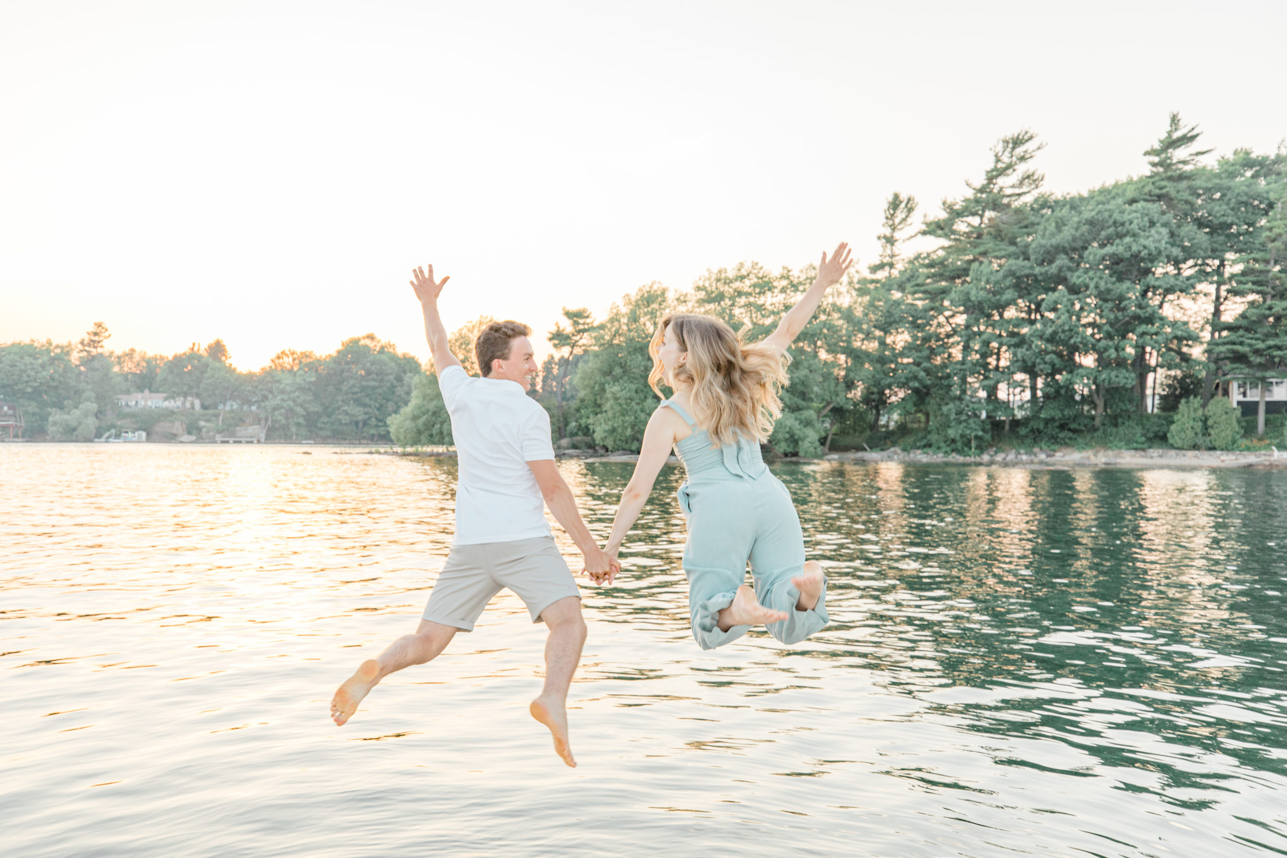 jumping into water during engagement session
