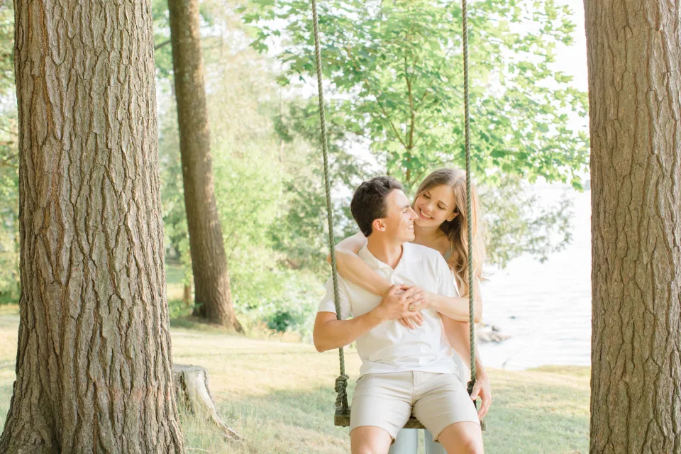 Swing Engagement Photo Inspiration - Ideas for what to wear for Engagement Photography, Modern Engagement Session Inspiration Wardrobe Ideas. Unsure of what to wear for your engagement photos, we've got you! Romantic blue Romper and neutral Shirts and polo. Boat Shoes and Flip Flops. Engagement in Gananoque. Grey Loft Studio is Ottawa's Wedding and Engagement Photographer Videographer for Real couples, showcasing photos that are modern, bright, and fun.